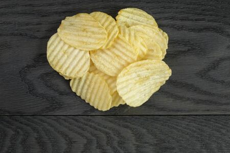 rippled organic chips on wooden tableの写真素材
