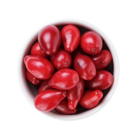 fresh bogwood berries in white bowl from above isolated on whiteの写真素材