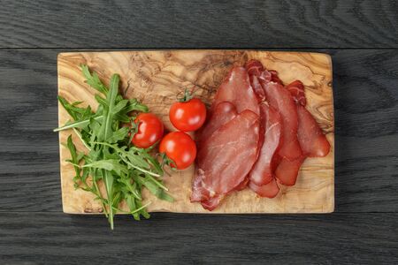 smoked ham prsut with cherry tomatoes and arugulaの写真素材