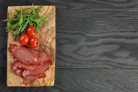 smoked ham prsut with cherry tomatoes and arugulaの写真素材