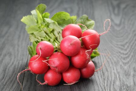 freshly harvested radishes on rustic table, shallow dofの写真素材