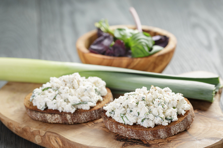 rye sandwiches or bruschetta with ricotta cheese and herbsの写真素材