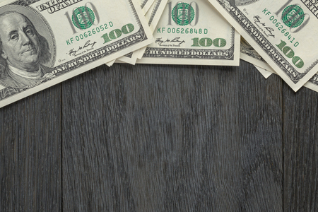 border from dollar bills on wooden tableの写真素材