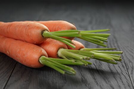 fresh organic carrots on wooden tableの写真素材