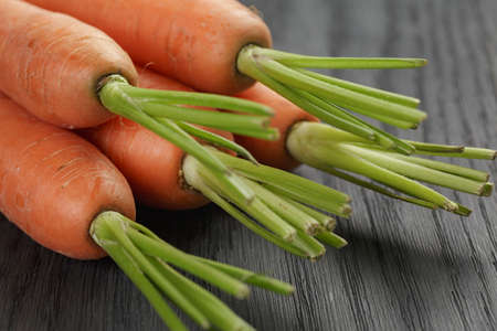 fresh organic carrots on wooden tableの写真素材