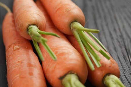 fresh organic carrots on wooden tableの写真素材