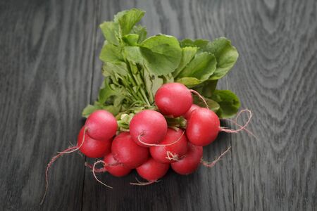 freshly harvested radishes on rustic tableの写真素材