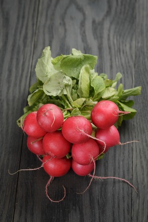 freshly harvested radishes on rustic tableの写真素材