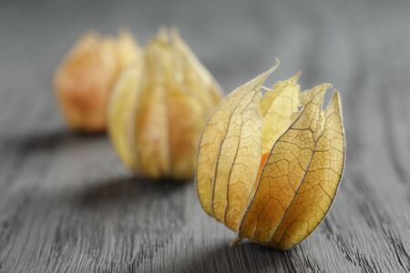 Physalis fruit on oak wooden tableの写真素材