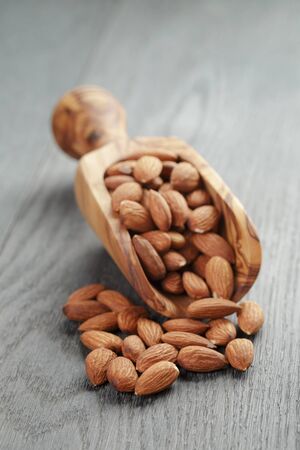 roasted almonds on gray wooden table, shallow focusの写真素材