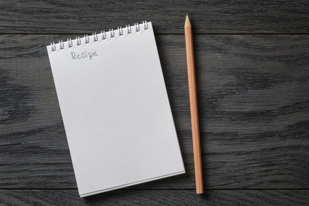 simple blank notepad with word recipe on rustic wood table, backgroundの写真素材