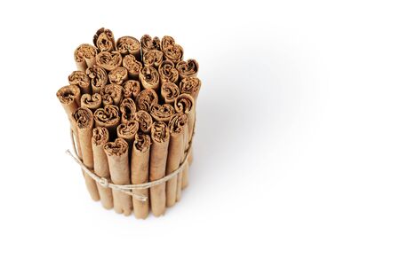 tied true ceylon cinnamon sticks, isolated on white backgroundの写真素材