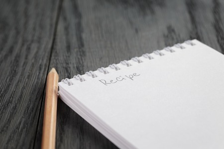 closeup photo of open notepad with word recipe, on wood tableの写真素材