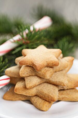 star cookies and candy cane on table, rustic photoの写真素材
