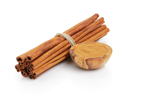 cinnamon sticks with powder, isolated on white backgroundの写真素材