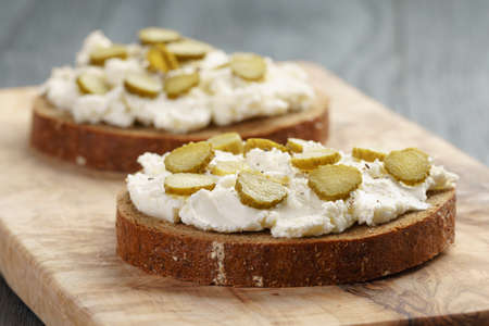 sandwiches with rye bread, cream cheese and marinated cucumbers, rustic foodの写真素材