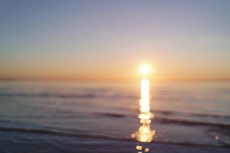 real optical blurred photo of sunset on sea beach, for backgroundの写真素材
