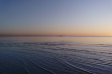 real optical blurred photo of sunset on sea beach, for backgroundの写真素材