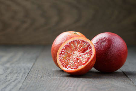 red sicilian oranges sliced on wooden tableの写真素材
