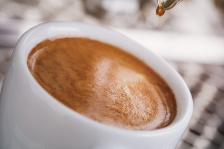 coffee extraction from professional coffee machine, toned photoの写真素材