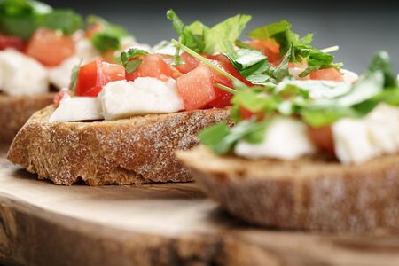 rye bruschetta with mozzarella, tomatoes and parsley, selective focusの写真素材