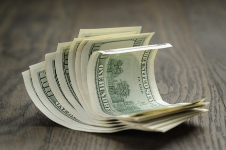 hundred dollar bills on wood table, simple styleの写真素材