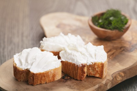 homemade appetizing crostini with soft cheese cream herbs, vintage tonedの写真素材