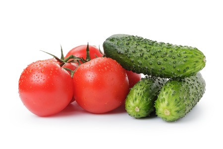 ripe tomatoes and cucumbers isolated on whiteの写真素材