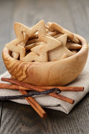 classic star cookies in wood bowl on wooden table, vintage tonedの写真素材