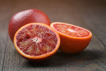 red sicilian oranges sliced on wooden table, vintage tonedの写真素材