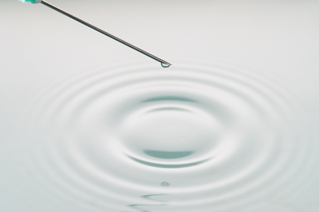 liquid drop on the tip of syringe, shallow focusの写真素材