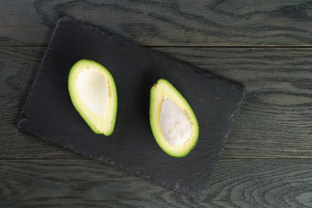 ripe avocados on slate board, shallow focusの写真素材