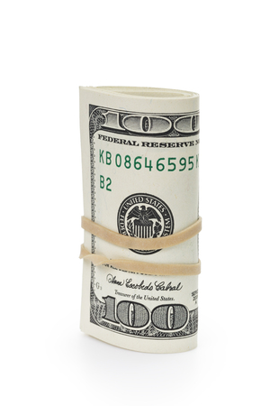 bunch of hundred dollar bills tied with rubber band, isolated on white backgroundの写真素材