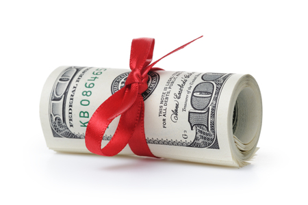 bunch of hundred dollar bills tied with ribbon, isolated on white backgroundの写真素材