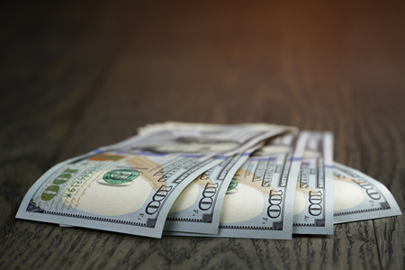 hundred dollar bills on wood table, simple styleの写真素材