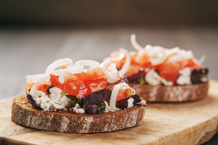 rye sandwich or bruschetta with ricotta, herbs and tomato closeupの写真素材