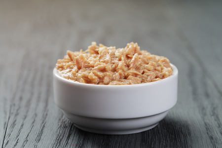 canned tuna in white bowl on wood table, shallow focusの写真素材