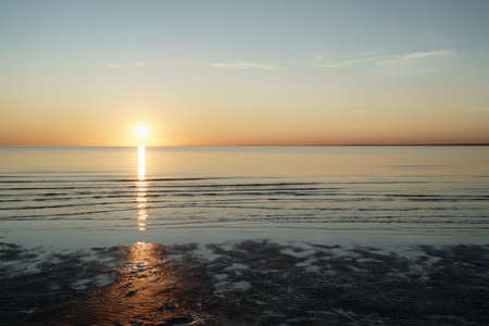 sunset above sea shot from beach, vintage toned