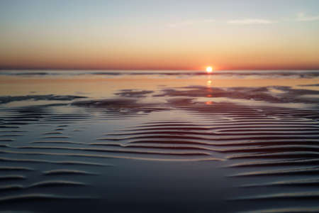 sunset above sea shot from beach, vintage toned