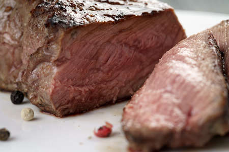 sliced beef steak on white plate close up, shallow focusの写真素材