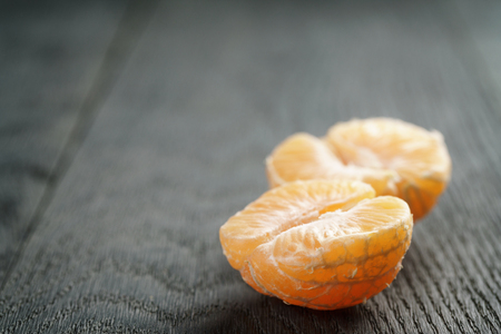 ripe tangerine peeled on wood table, shallow focusの写真素材