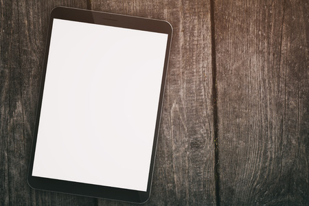 generic tablet pc with blank screen on wood table, directly aboveの写真素材