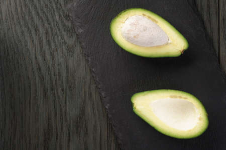 ripe green avocados on wood table, selective focusの写真素材