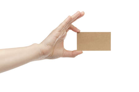 young female right hand hold blank brown paper card, isolated on whiteの写真素材