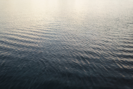 deep blue water surface of the bay, sunset reflectionの写真素材