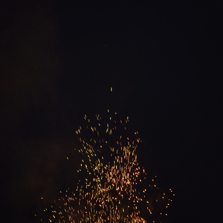sparks from bonfire in the night with dark background, outdoor