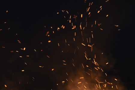 firecamp sparks over night sky, black backgroundの写真素材