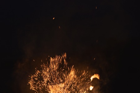 firecamp sparks over night sky, black background
