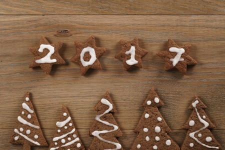 gingerbread chocolate cookies over wood table forms composition, christmas themeの写真素材