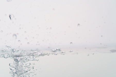 pouring water in aquarium with splash and bubbles, backdropの写真素材